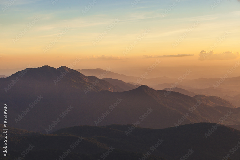 Golden sky with sunlight and the Mountains in sunset.