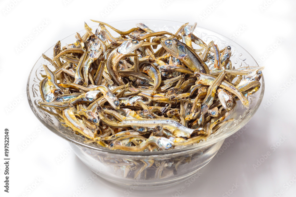 Close up of Japanese dried infant sardine used as seasoning in Japanese foods and cooking. Japanese healthy snack food. Niboshi or Iriko fish close up. Close up of Japanese dried infant sardine used as seasoning in Japanese foods and cooking. Japanese healthy snack food. Niboshi or Iriko fish close up.