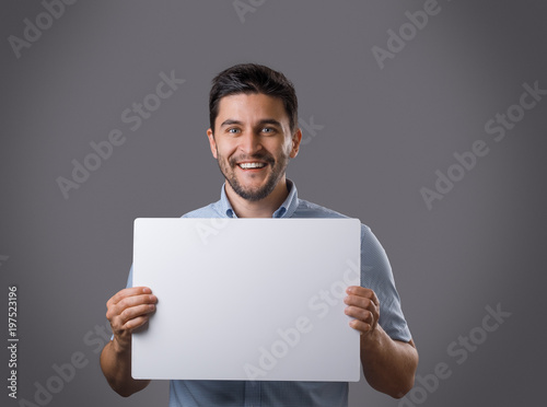 Youn man holds board