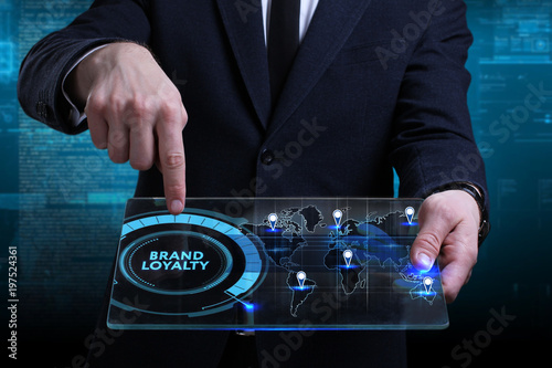 Business, Technology, Internet and network concept. Young businessman working on a virtual screen of the future and sees the inscription: Brand loyalty