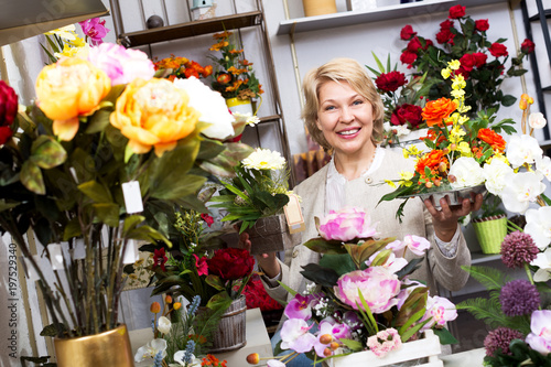 Woman smiling among multicolored flowers