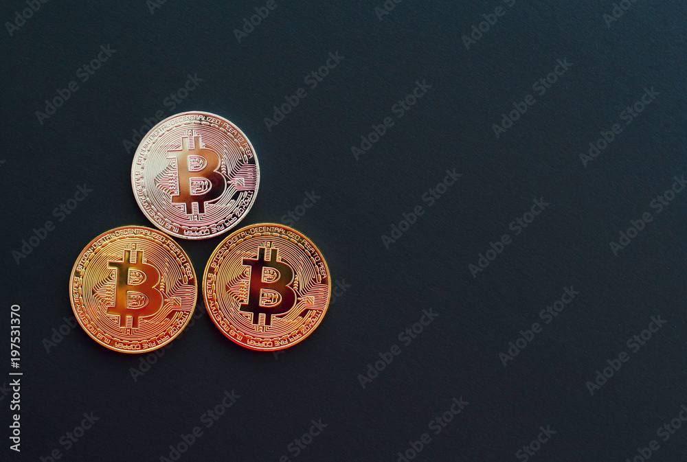 Picture of three gold bitcoin over black background. Digital money concept Picture of three gold bitcoin over black background. Digital money concept