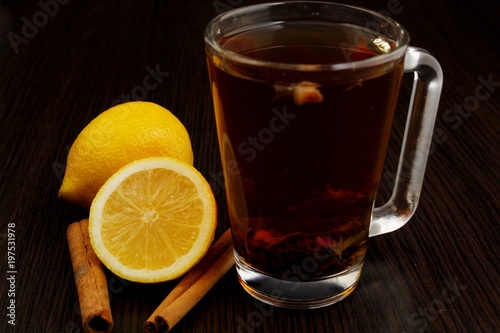 tea with lemon and cinnamon on a wooden table