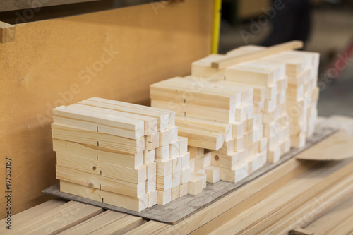 production  manufacture and woodworking industry concept - wooden boards at workshop or storehouse