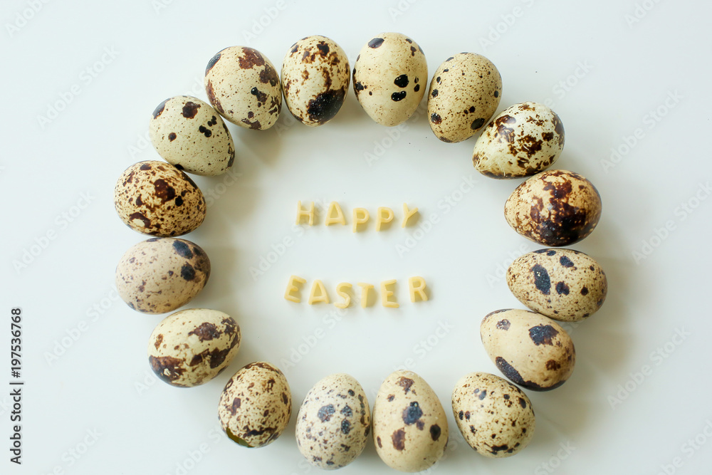  Happy easter, inscription from the letters of pasta, next to quail eggs on white background