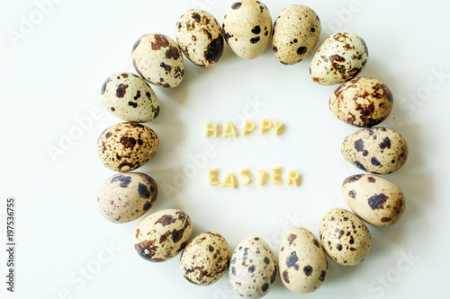  Happy easter, inscription from the letters of pasta, next to quail eggs on white background
