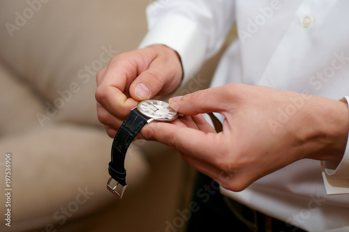  large hand of a man, groom during wedding gathering with accessories
