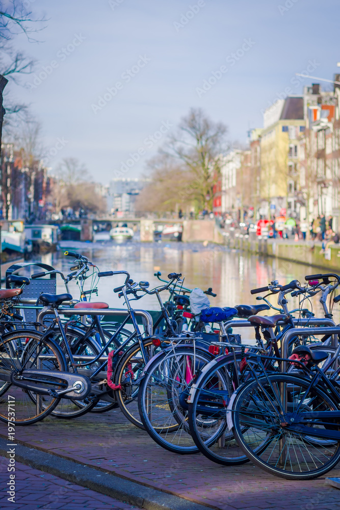 Outdoor view of bycicles parked at the bridge in Amsterdam