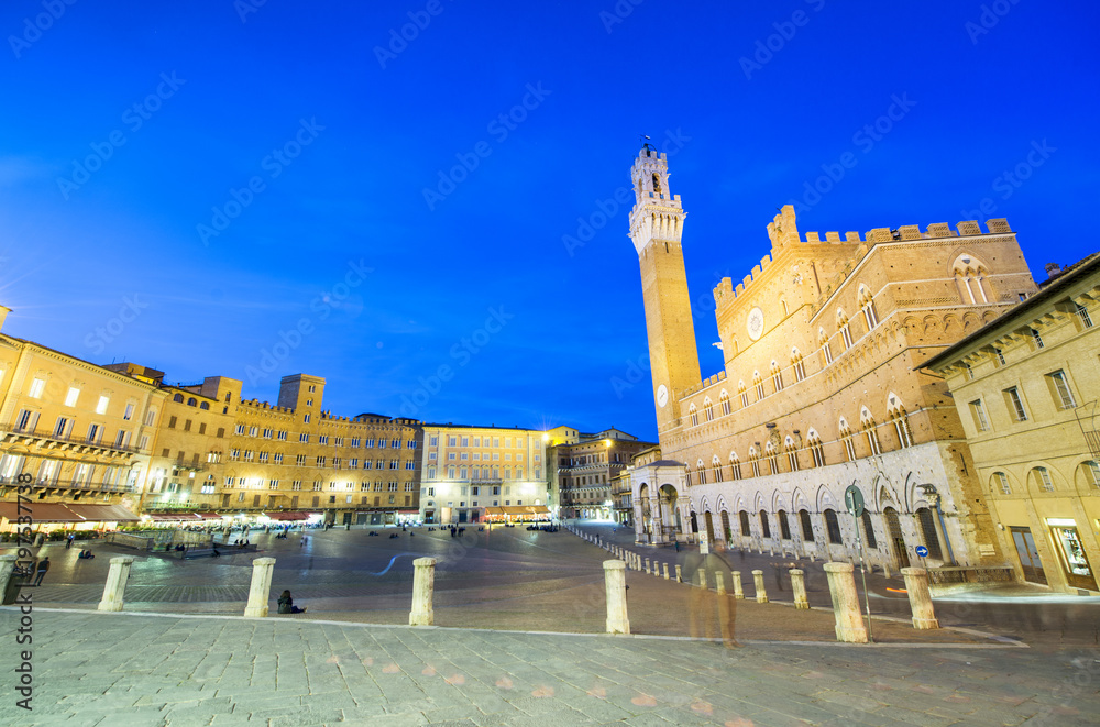 SIENA, ITALY - APRIL 2016: Night view of Piazza del Campo. Siena attracts 5 million tourists annually