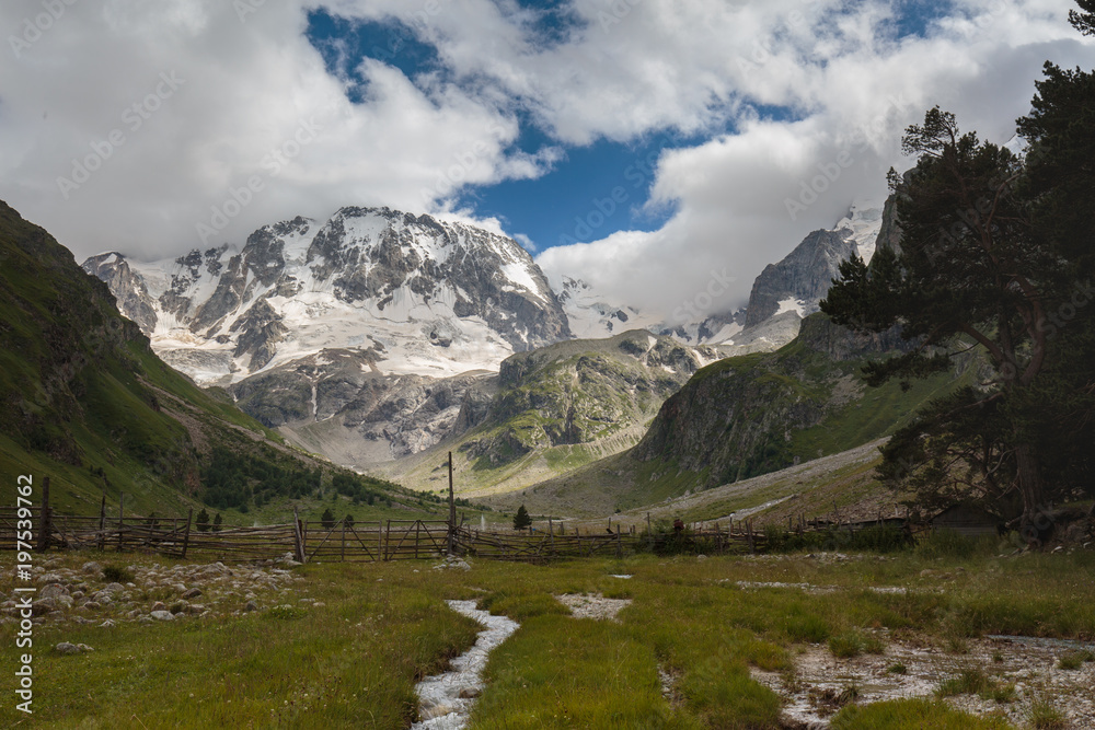 Movement of clouds and water flows in a stormy river in the Caucasus mountains in summer