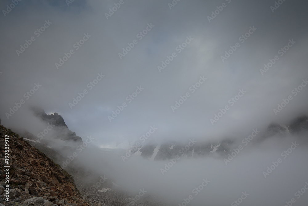Movement of clouds and water flows in a stormy river in the Caucasus mountains in summer