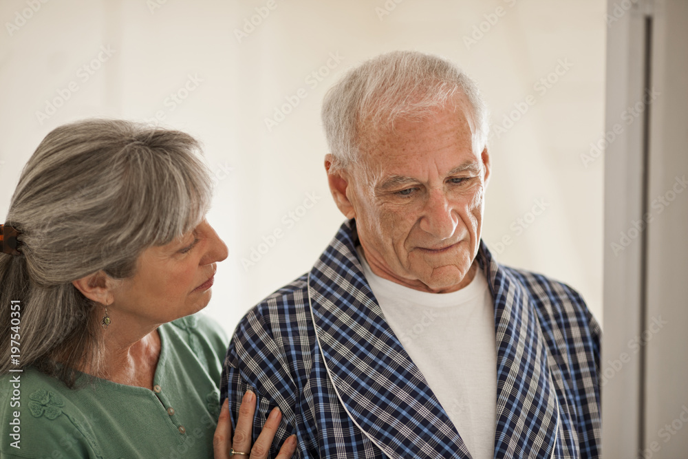 Senior woman comforting her unwell husband. Senior woman comforting her unwell husband.