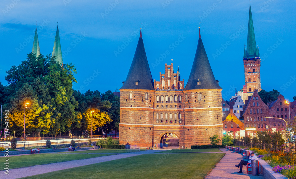 Medieval Holstentor gate at night, Lubeck, Germany