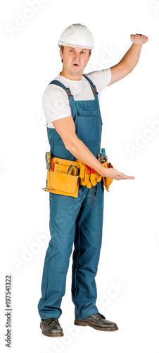 male builder or manual worker in helmet over white wall background. repair, construction, building, people and maintenance concept