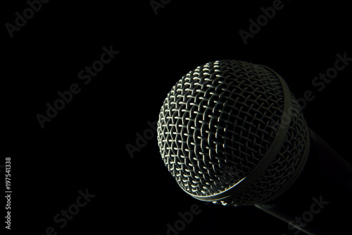 Isolated microphone head against pitch black background © Filmaroid