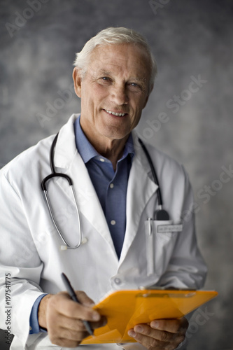 Portrait of a smiling doctor holding a clipboard