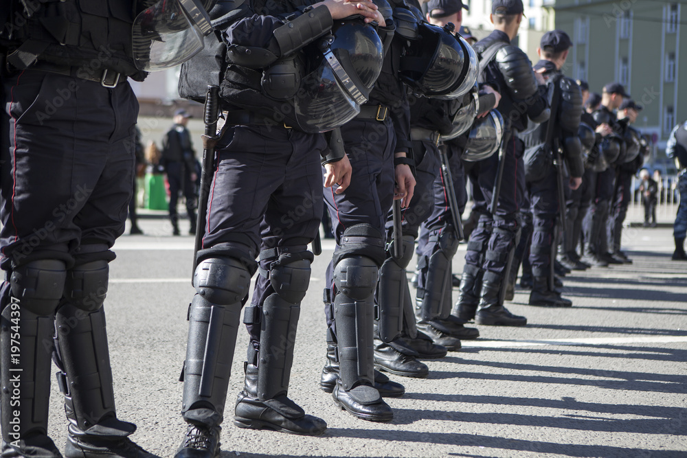 Russian policemen stand in a row, blocking the way to the metro Russian policemen stand in a row, blocking the way to the metro