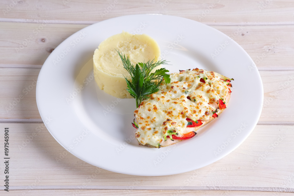Fried chicken fillet with bell pepper, zucchini, melted cheese and mashed potato