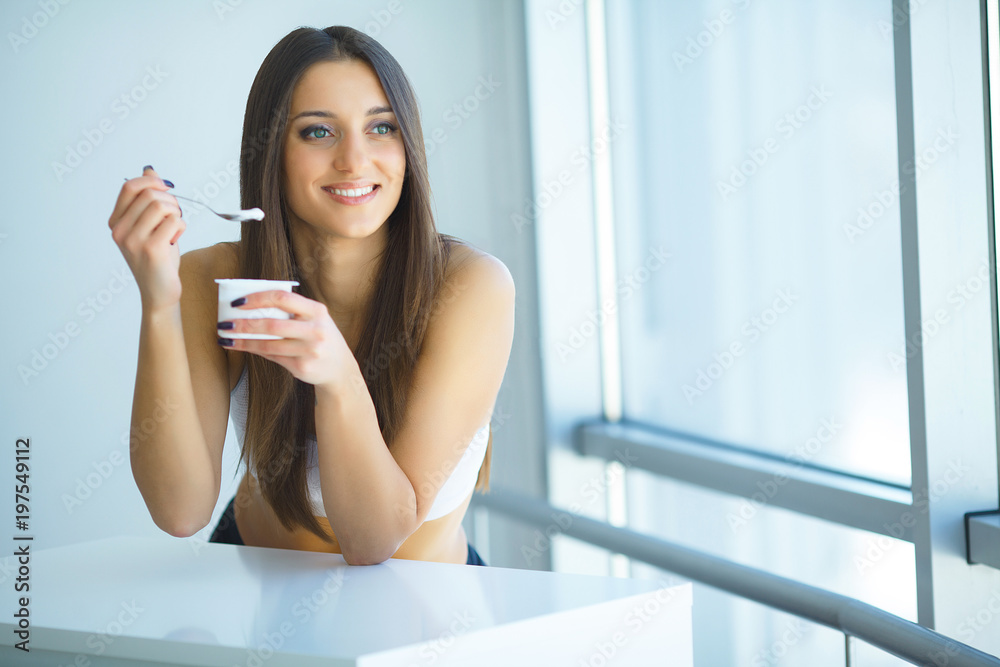 Portrait Of Smiling Woman Eating Yoghurt
