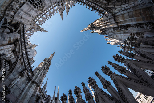 Skywards view to the ornate towers of the Duomo Cathedral in Milan, Italy