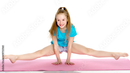 girl gymnast performs a handstand.
