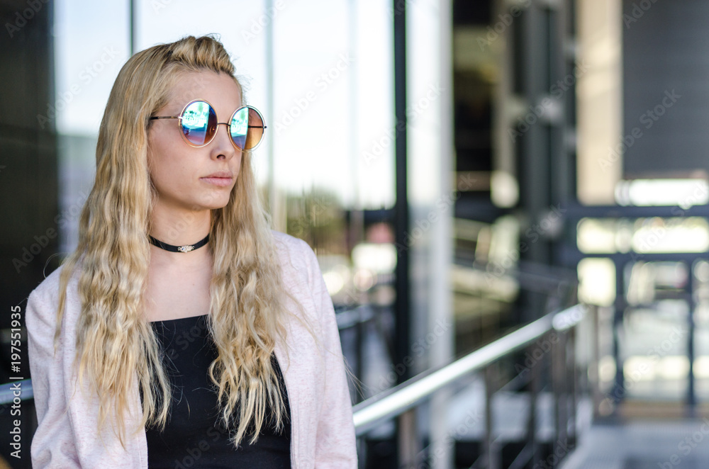 pretty blonde woman portrait at glass wall pretty blonde woman portrait at glass wall