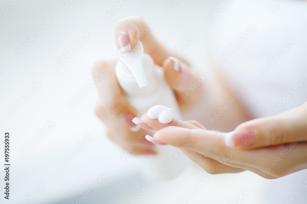 Naklejka premium Hand Skin Care. Close Up Of Female Hands Holding Cream Tube, Beautiful Woman Hands With Natural Manicure Nails Applying Cosmetic Hand Cream On Soft Silky Healthy Skin.
