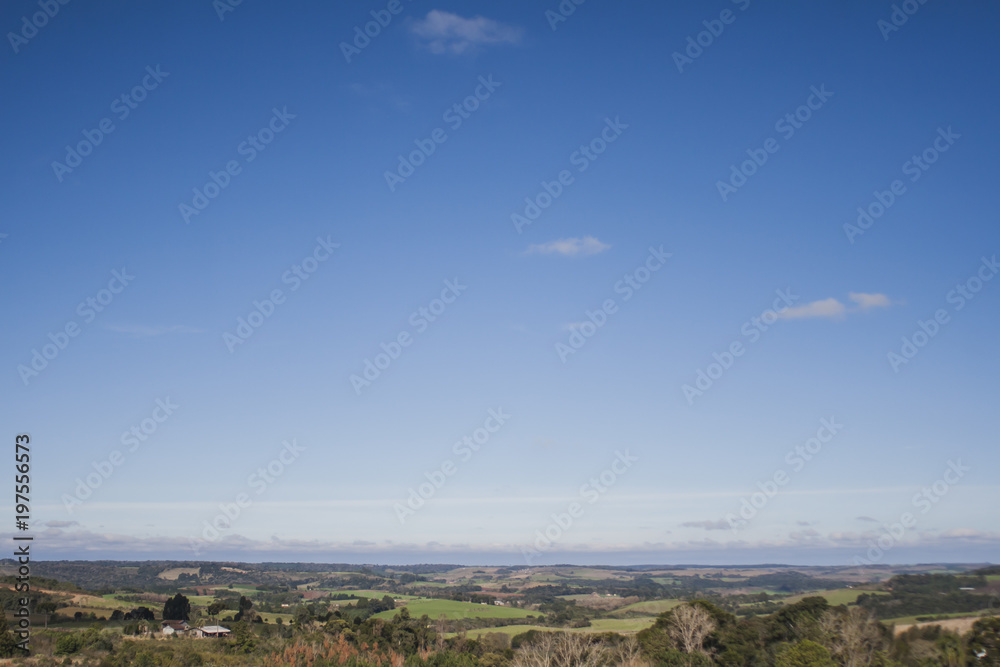 Panoramic view of a rural landscape with forest. Blue sky with clouds. Frei Rogério, Santa Catarina / Brazil