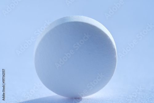 Pill tablet medicine lying isolated on white  extreme close-up macro.