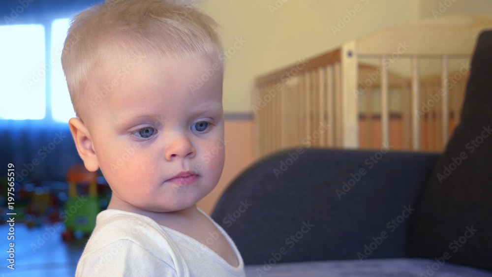 Toddler boy playing, blond, blue eyes.