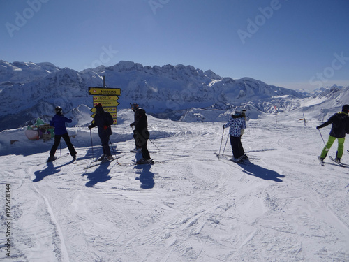 Silhouettes of skiers high in the Portes du Soleil photo