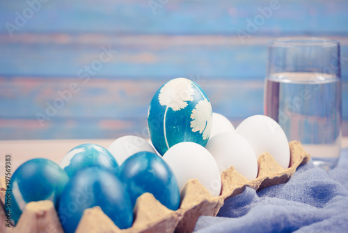 Happy easter, organic blue easter egg standing on the white color eggs wait for painting, easter holiday decorations, easter concept backgrounds