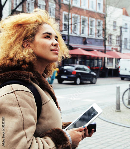 Photography young pretty african american girl with curly hair making photo
