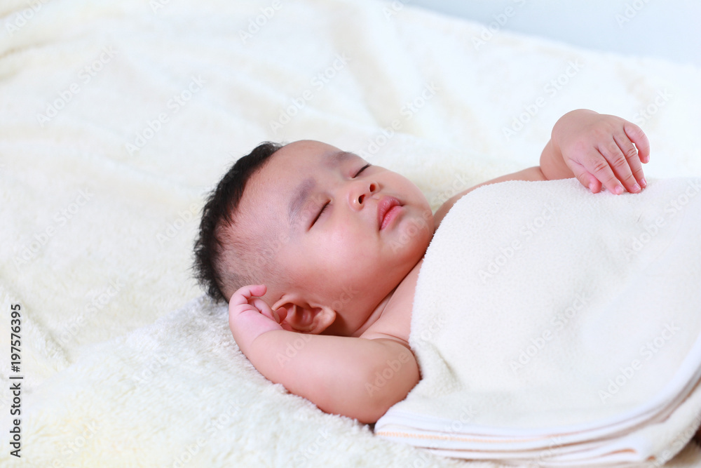 Asian Baby boy sweetly sleeps in white bed Asian Baby boy sweetly sleeps in white bed