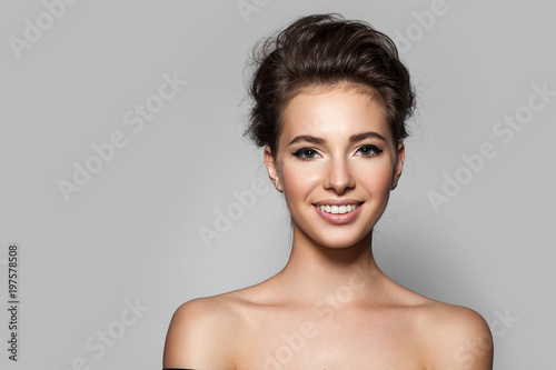 Young beautiful woman with perfect skin with black arrows on the eyes and white teeth. Smiling at the camera