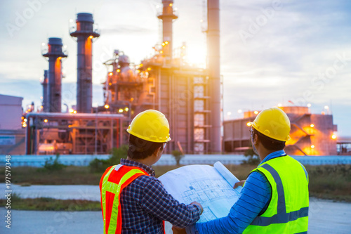 Industrial engineering working in a power plant, teamwork twilight