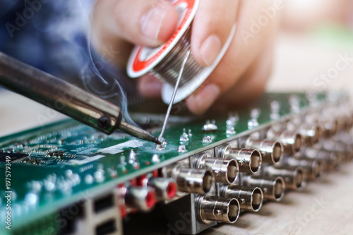 Technician desolder remove part component on board electronic for repair.