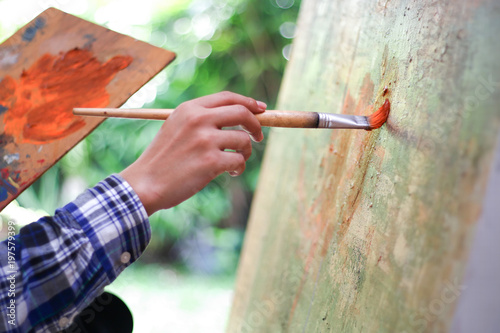 artist using a drawing brush.