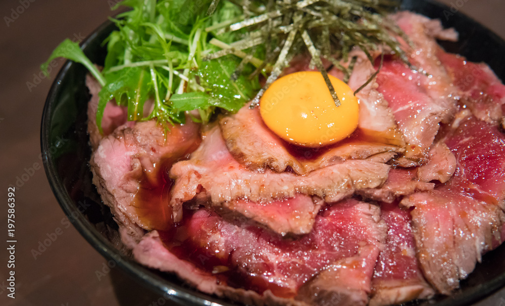 Japanese gyudon raw beef on a rice topping with raw egg, Osaka, Japan Japanese gyudon raw beef on a rice topping with raw egg, Osaka, Japan