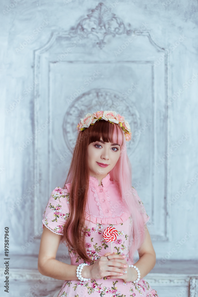 Beautiful young woman doll in a pink dress, with a lollipop, lolita.  Japanese street fashion. Portrait. Stock Photo | Adobe Stock