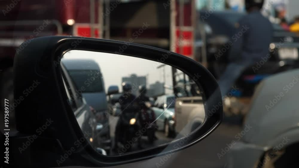 traffic jam in rush hour of city life, focus on side mirror of vehicle car traffic jam in rush hour of city life, focus on side mirror of vehicle car
