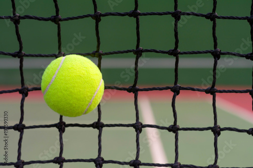 Tennis ball hitting to net on blur tennis court background © WK Stock Photo 