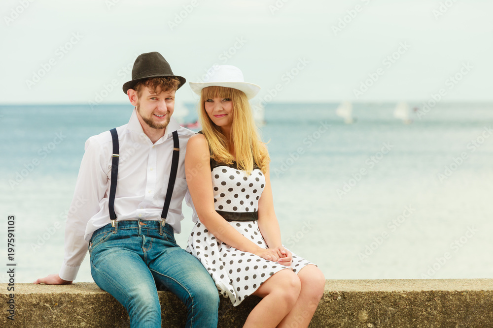 Loving couple retro style dating on sea coast