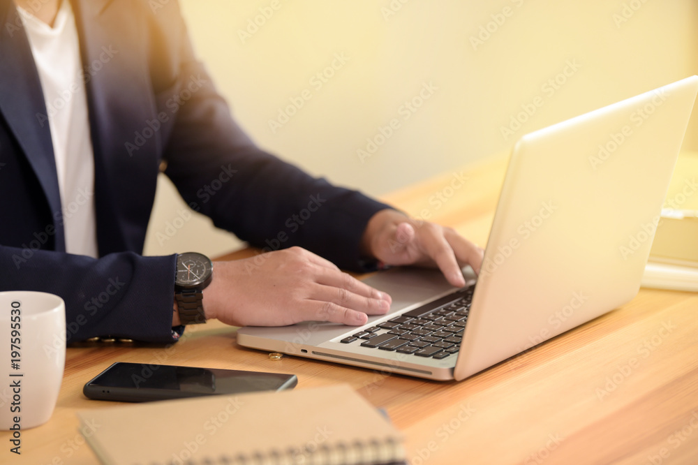Portrait of young man sitting at his desk in the office Portrait of young man sitting at his desk in the office
