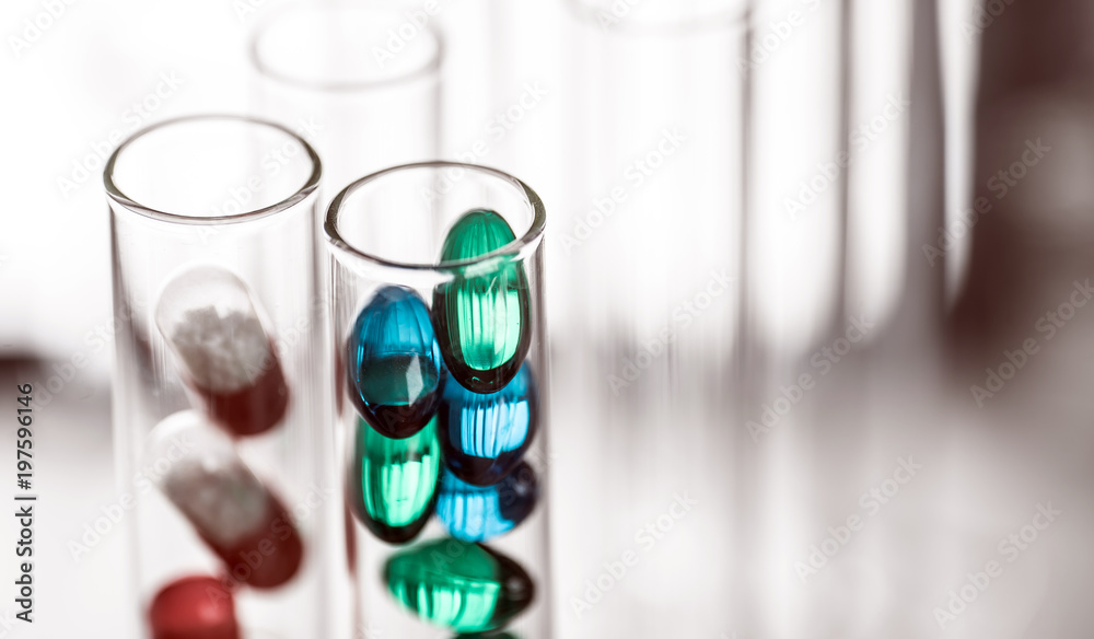 Laboratory Microscope, pills and test tubes. Scientific and healthcare research background. Laboratory Microscope, pills and test tubes. Scientific and healthcare research background.