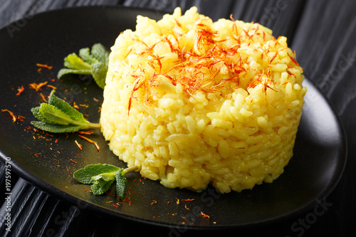 risotto from rice carnaroli with saffron and mint closeup. horizontal view