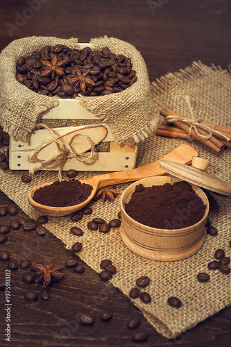 Coffee beans in a wooden box, buckwheat and cinnamon sticks.