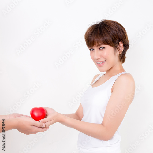 Man give the red heart to the young asia woman. Isolated on white background. Studio lighting. Concept for healthy.