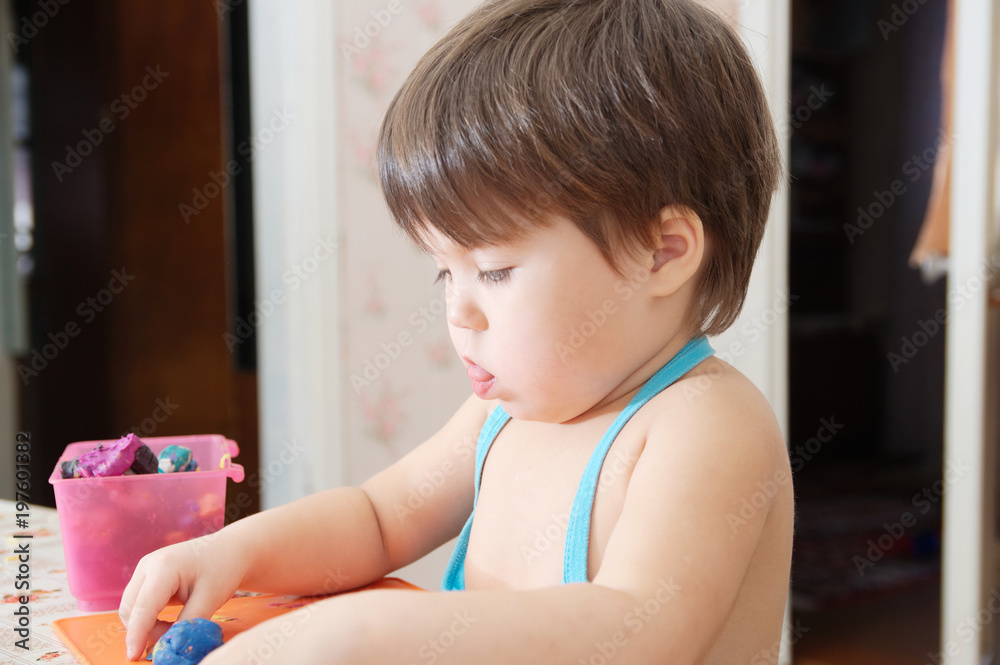 Little girl playing with plasticine forming figure at home Little girl playing with plasticine forming figure at home