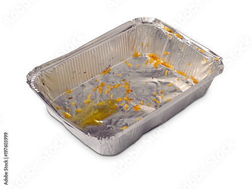 Empty dirty foil dish with rice grains and oil